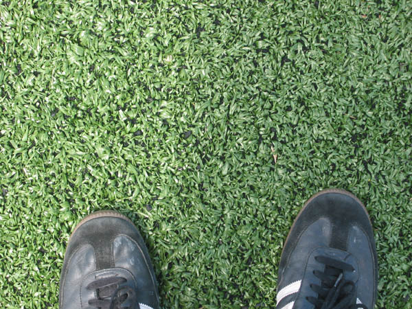A closeup of the FieldTurf and my Adidas Sambas