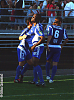 A goal celebration with a ball under the shirt and a look into the setting sun